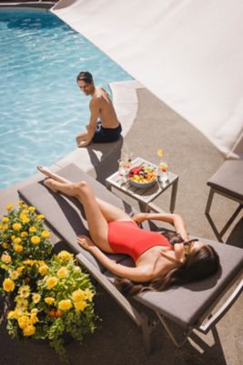Couple lounging poolside at the luxurious Fairmont Chateau Whistler