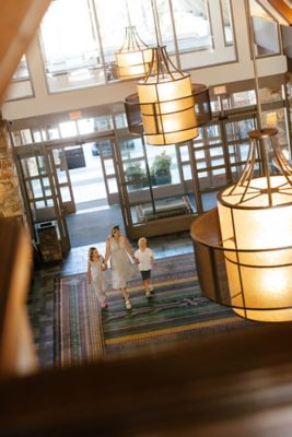 mother and kids arriving to fairmont chateau whistler holding hands