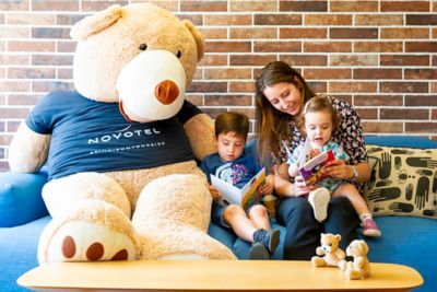 Kids happily reading in a family-friendly Novotel hotel