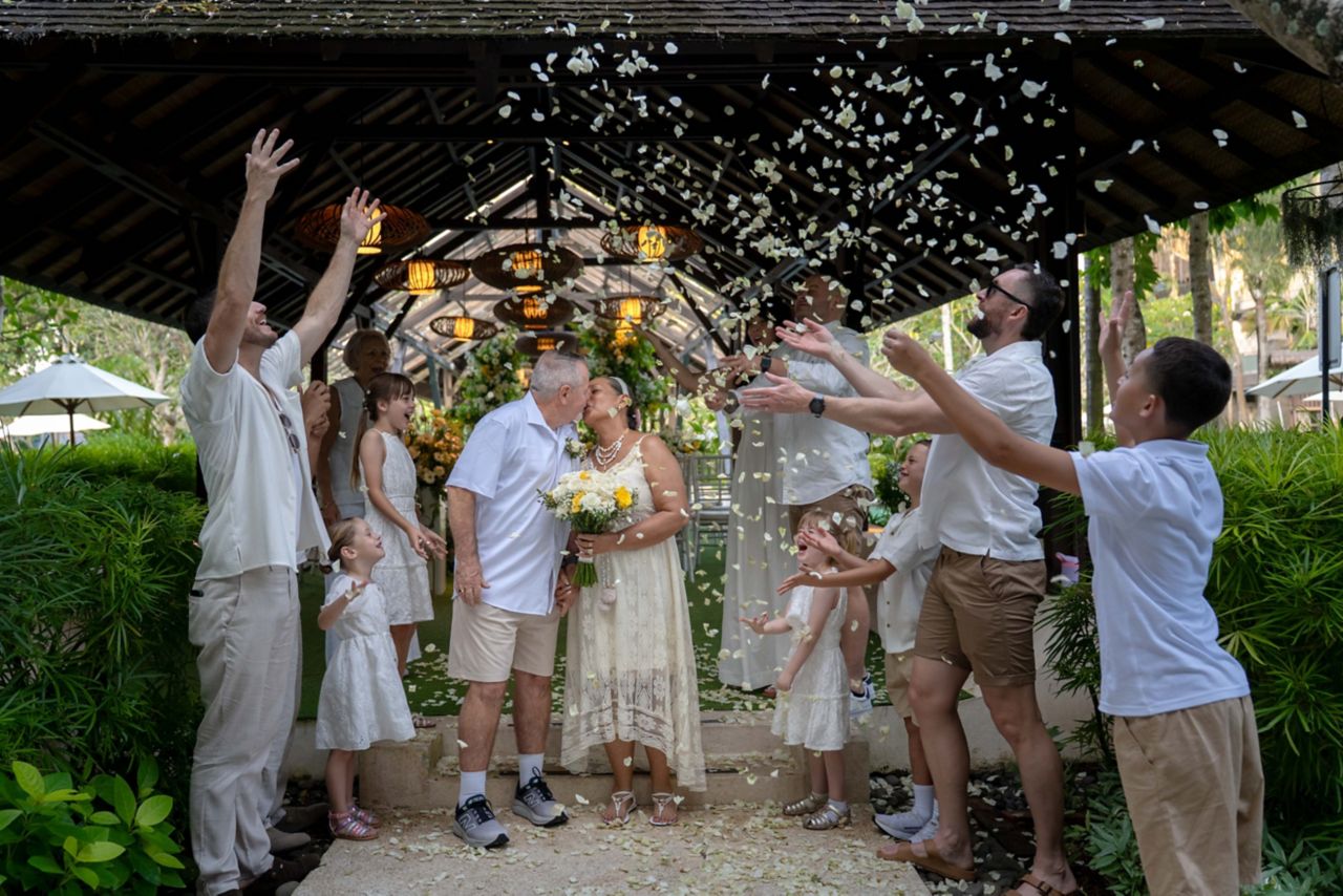 Outdoor wedding celebration with flower petals being thrown at Mövenpick Resort Petra