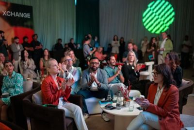 Guests attend a Pullman xChange event, listening to speakers and participating in a shared cultural experience.