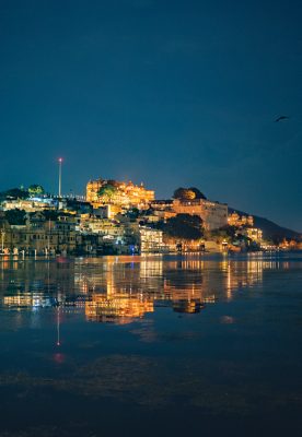 Illuminated City Palace on Lake Pichola at Night