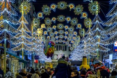 People strolling under beautiful Christmas lights in Montbéliard, Alsace