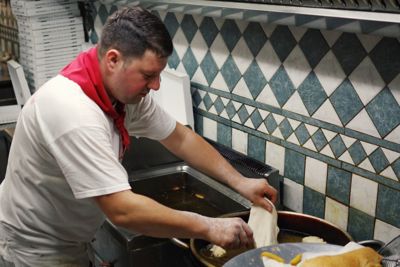 An Italian chef at work in a pizza restaurant