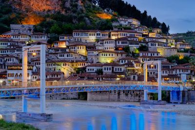 White hillside Ottoman houses with many windows at sunset in Berat, Albania