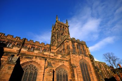 The imposing red-brick façade of a medieval church in Wolverhampton