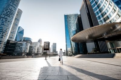 A business traveller taking alone time amid the skyscrapers of Paris's La Défense district