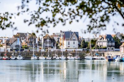 Half-timbered houses overlooking a peaceful, yacht-filled marina in Deauville
