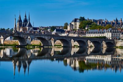 Gothic spires and a wide stone bridge in riverfront Blois, Loire Valley