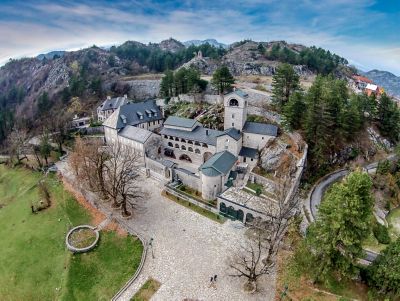 Elegant Cetinje Monastery in Montenegro, surrounded by rugged, pine-covered cliffs