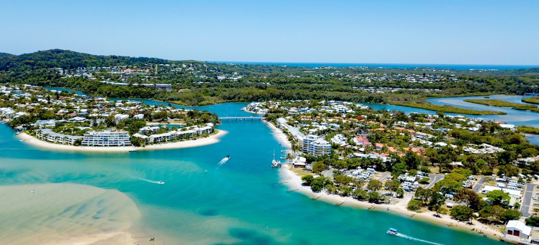 An aerial view of the Noosa River on a clear day with blue water