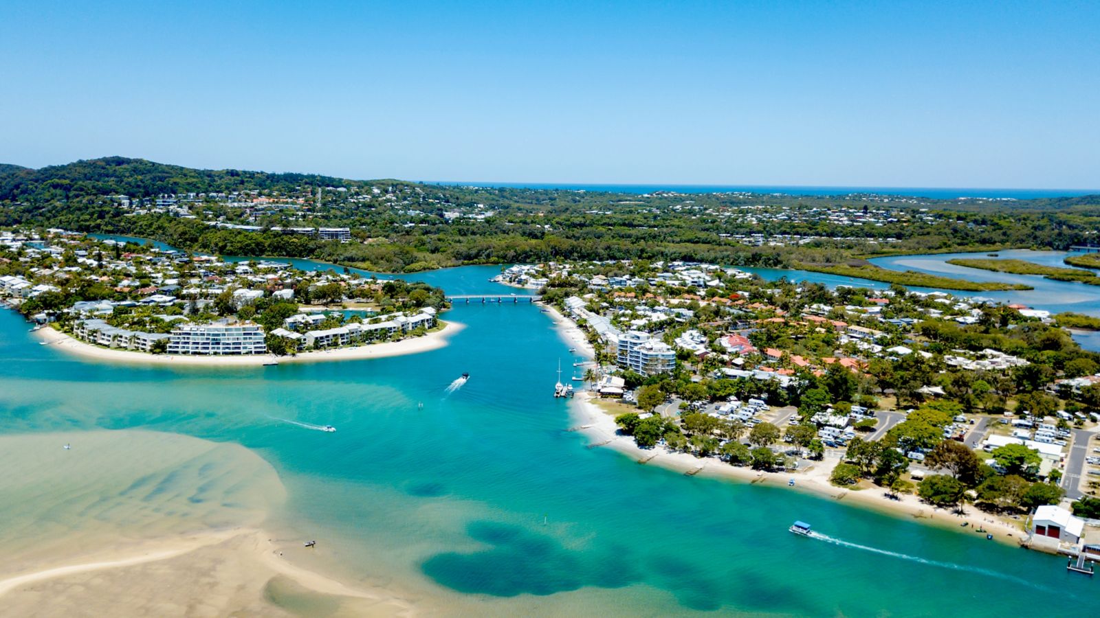 An aerial view of the Noosa River on a clear day with blue water