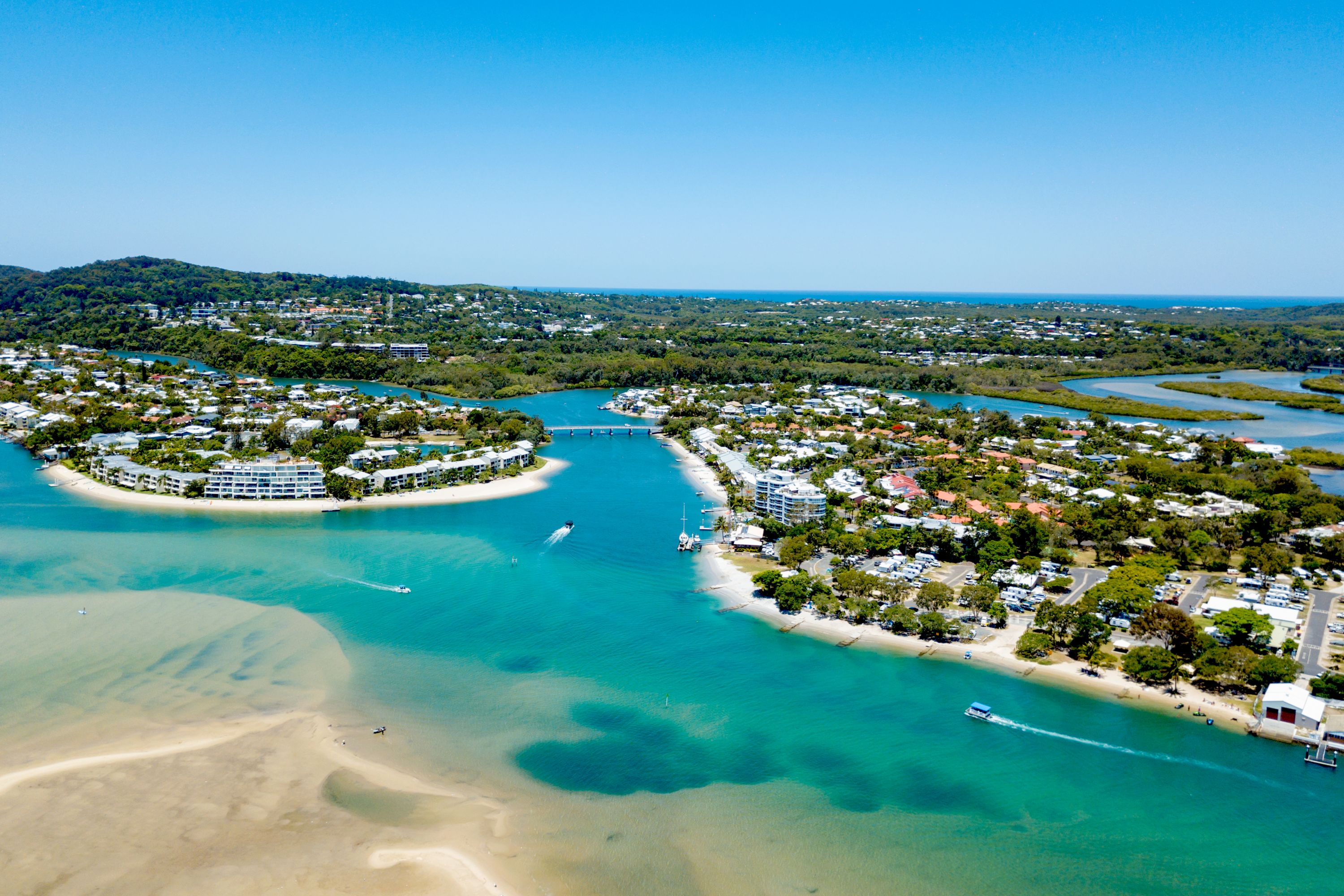 An aerial view of the Noosa River on a clear day with blue water