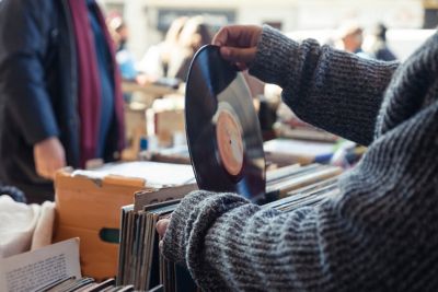 A shopper browsing vintage vinyl records at a flea market