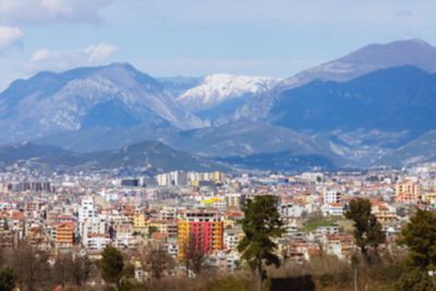Tirana's modern skyline backed by Dajti National Park's rugged mountains in Albania