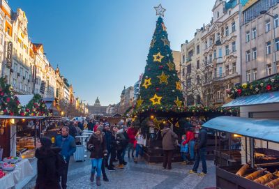 Visitors browsing Christmas market stalls in Prague's Wenceslas Square