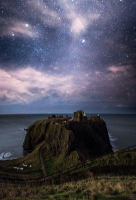 Dunnottar Castle on the Aberdeenshire coast under a night sky filled with stars