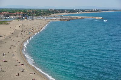 Beachgoers enjoying the wide, sandy expanse of Argelès-sur-Mer beach near Perpignan