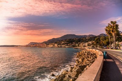 A dramatic pink and purple sunset over the Mediterranean in a French Riviera town