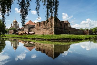 Tall exterior walls and wide moat of medieval Făgăraș Fortress