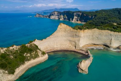 Expansive Cape Drastis in Corfu, Greece with steep cliffs, rugged mountains and the blue Ionian Sea
