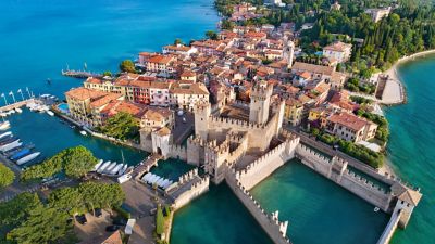 Sirmione am Gardasee mit Castello Scaligero vor türkisblauem Wasser aus der Vogelperspektive