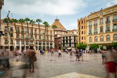 Plaza de la Constitución in Málaga, lined with tall palms and century-old buildings