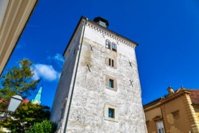 Whitewashed Lotrščak Tower in Zagreb, Croatia, looming against a blue sky