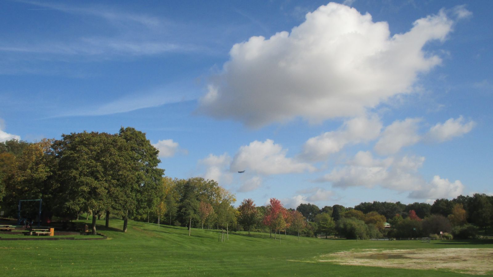 Autumn in Île-de-France: A Plane Soars Over a Public Park