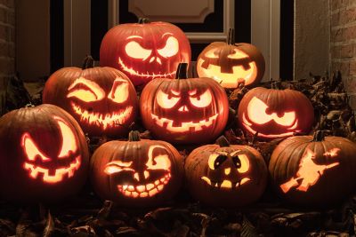 Illuminated carved pumpkins with different expressions