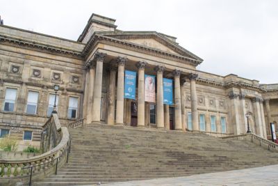 The grand entrance of the World Museum in Liverpool, with a wide, sweeping staircase