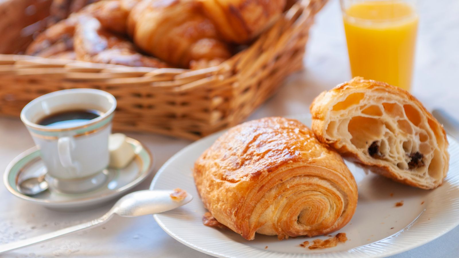A traditional French breakfast of pastries, coffee and orange juice