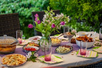A table set for outdoor dining in summery pinks and greens, ideal for hot weather