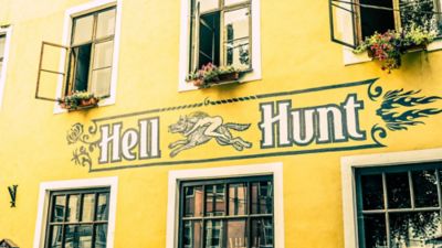 The pastel-yellow façade of the laidback Hell Hunt pub in Tallinn Old Town
