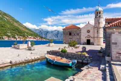 A church in Kotor Old Town near Perast in Montenegro, with the Adriatic Sea and steep cliffs