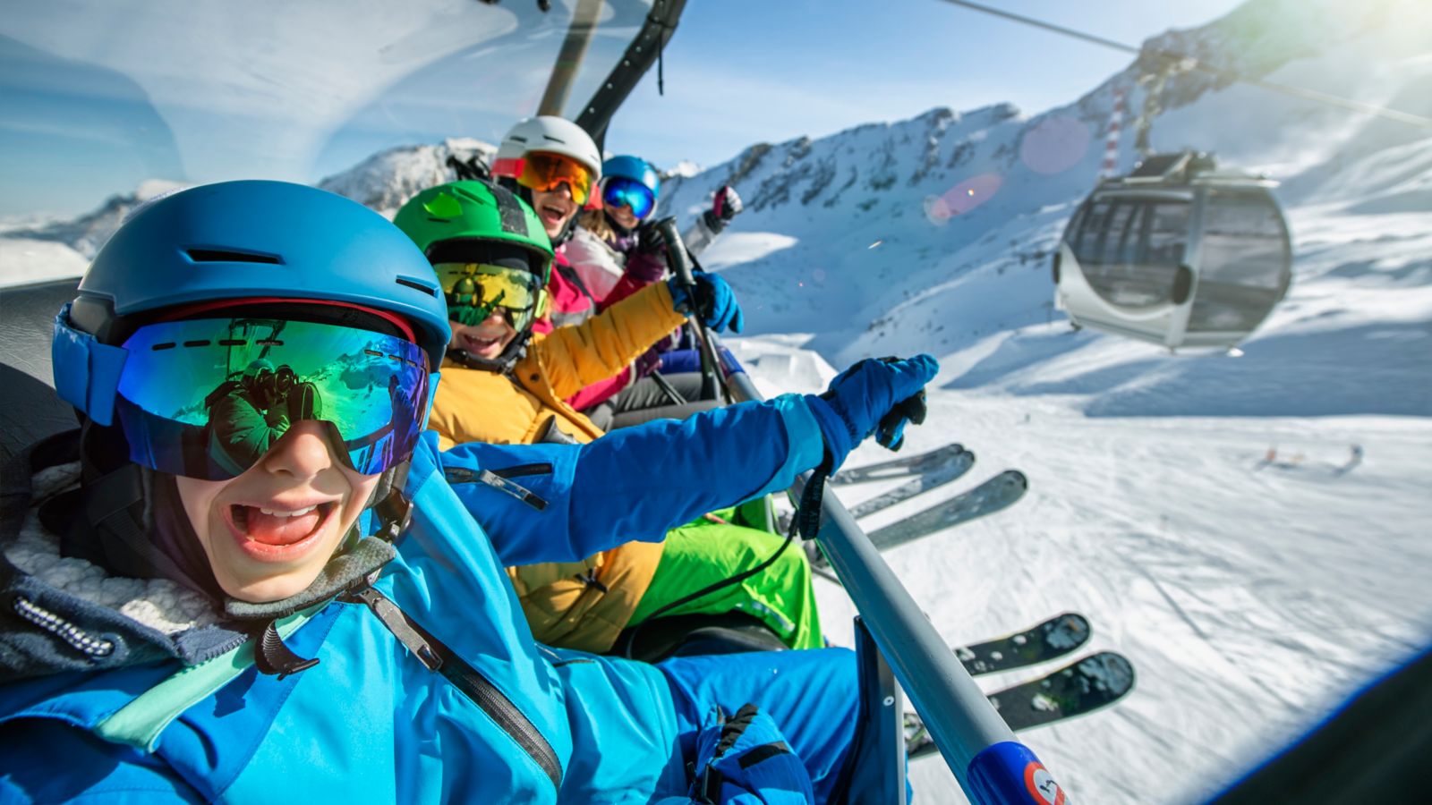 A happy family on a chairlift at a ski resort in the snowy Alps