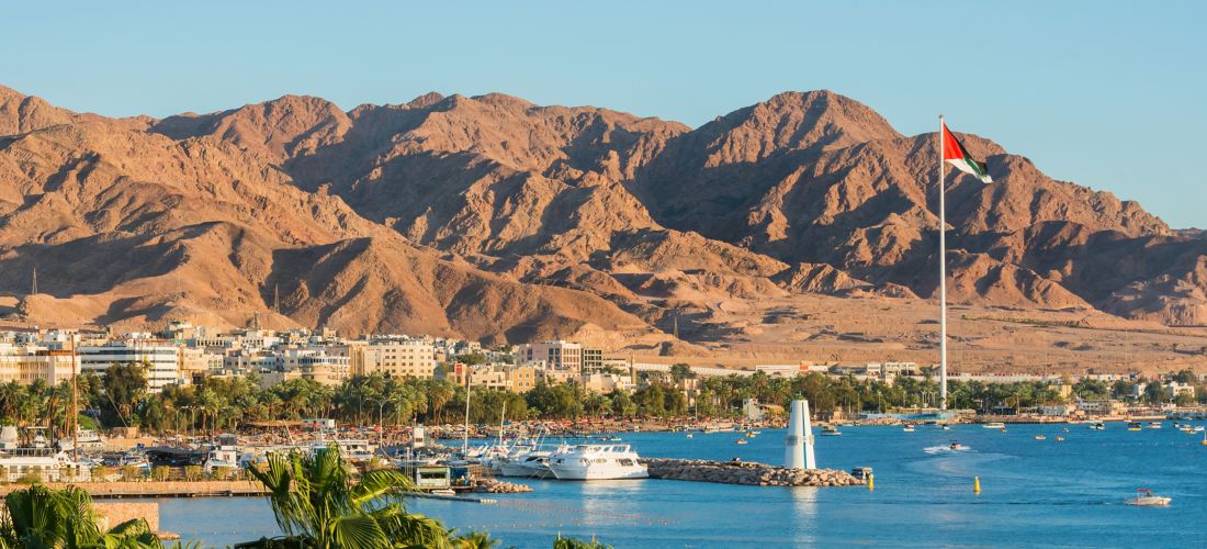 Scenic view of sea and mountains against clear blue sky,Aqaba,Jordan