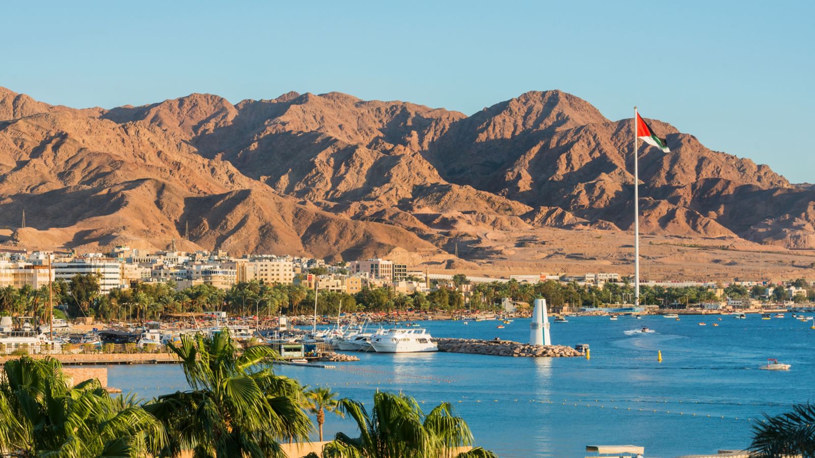 Scenic view of sea and mountains against clear blue sky,Aqaba,Jordan