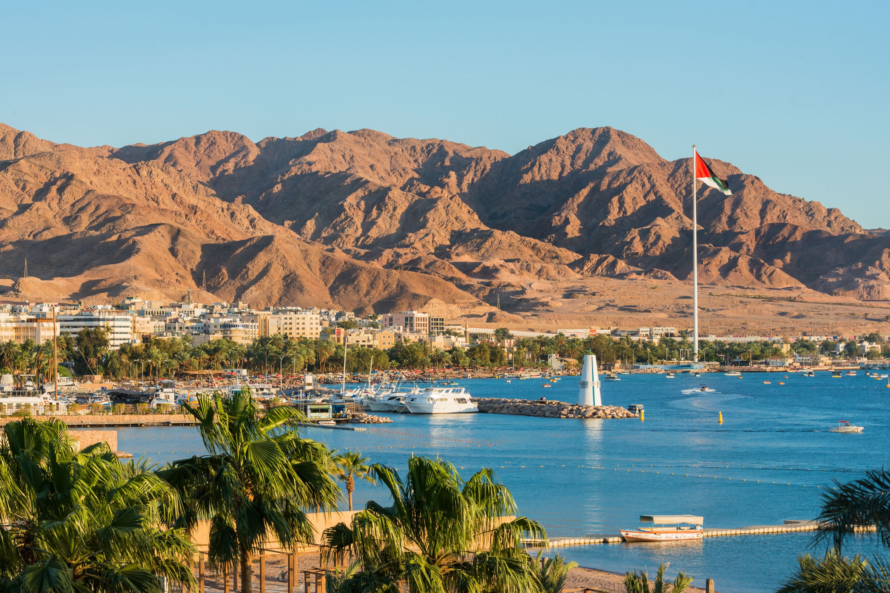 Scenic view of sea and mountains against clear blue sky,Aqaba,Jordan