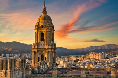 The tower and dome of Málaga Cathedral, a historic city landmark in a mix of styles