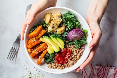 A diner engaging in mindful eating with a healthy, colourful salad