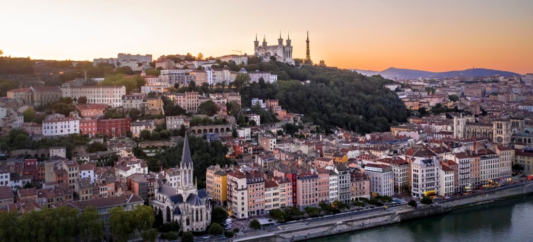Lyon at Dusk: Riverside Cityscape with Basilica