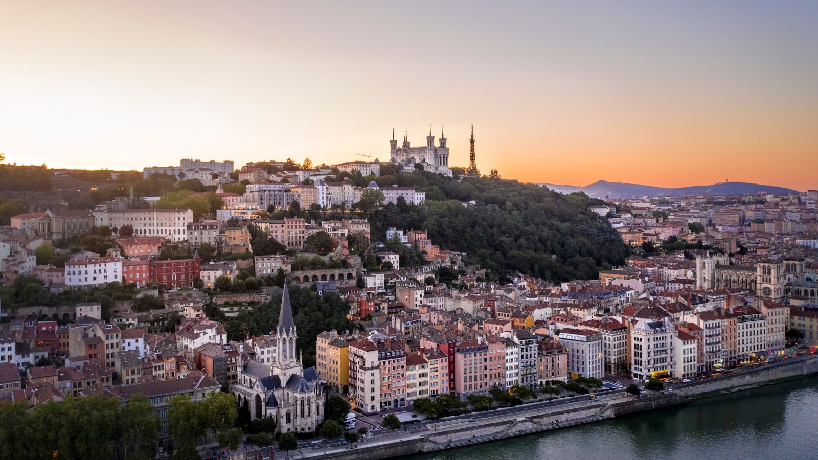 Lyon at Dusk: Riverside Cityscape with Basilica