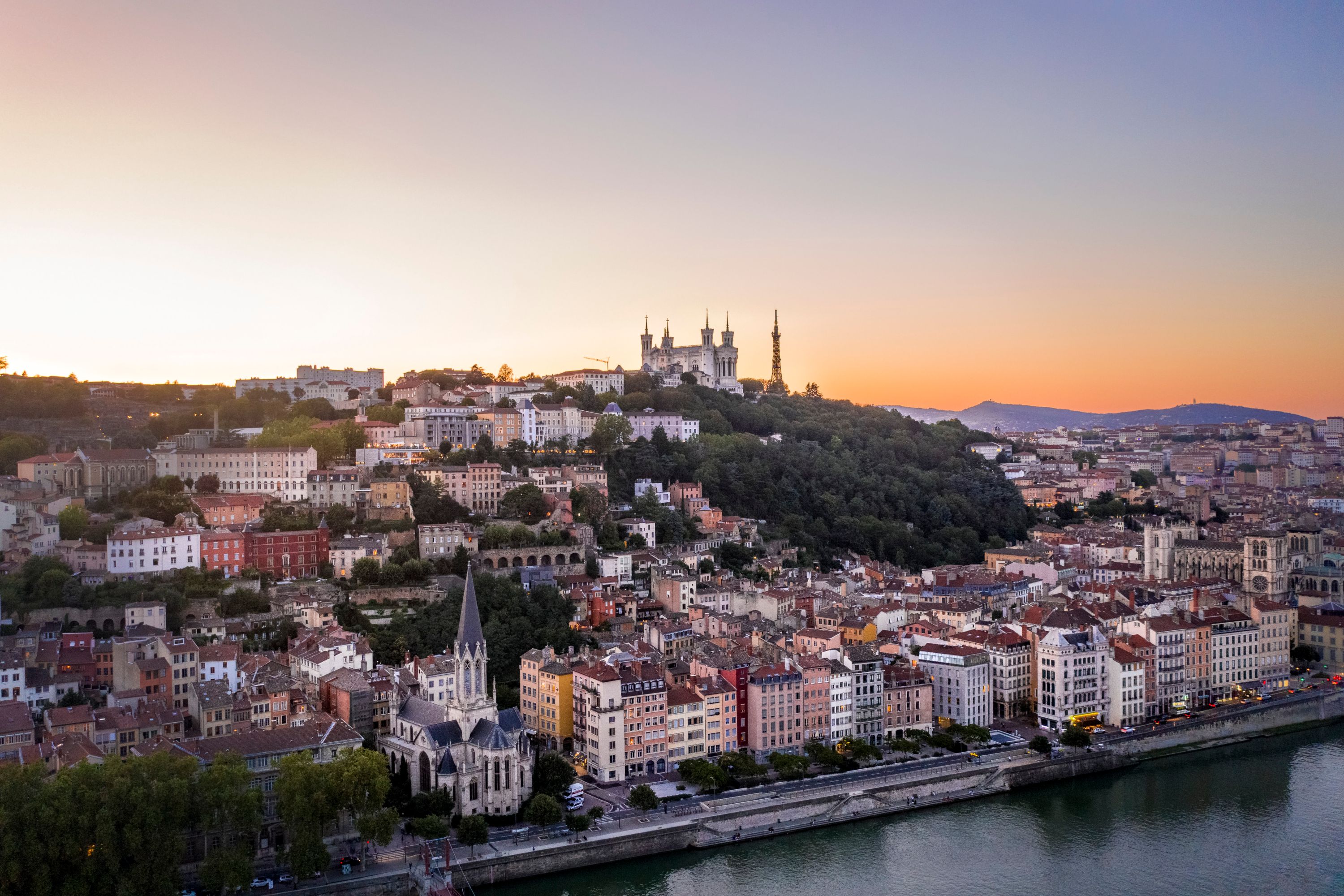 Lyon at Dusk: Riverside Cityscape with Basilica