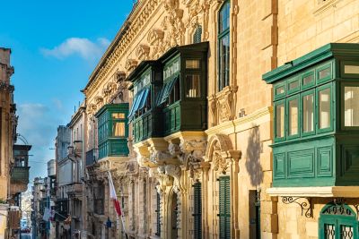 The green-painted balconies of historic townhouses in Valletta, Malta