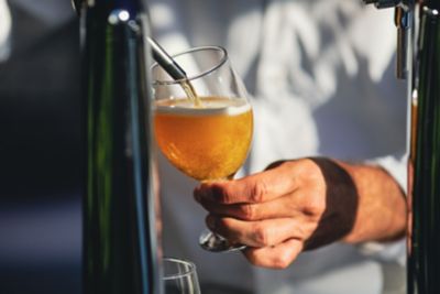 Golden, frothy artisan beer being poured into a goblet in Romania