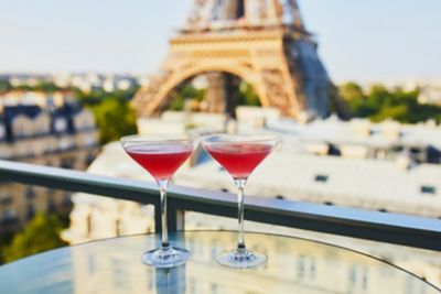 Dainty red cocktails at a rooftop bar with Eiffel Tower views in Paris