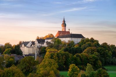 Peaceful Andechs Monastery surrounded by trees at sunrise