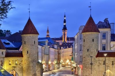 Tallinn Old Town's Gothic Town Hall and turreted Viru Gate, illuminated in the evening