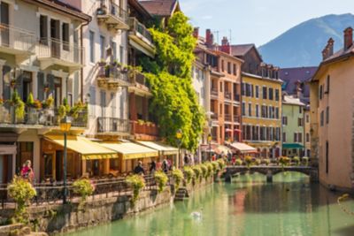 Terrace restaurants by the River Thiou on a summer's day in Annecy, France